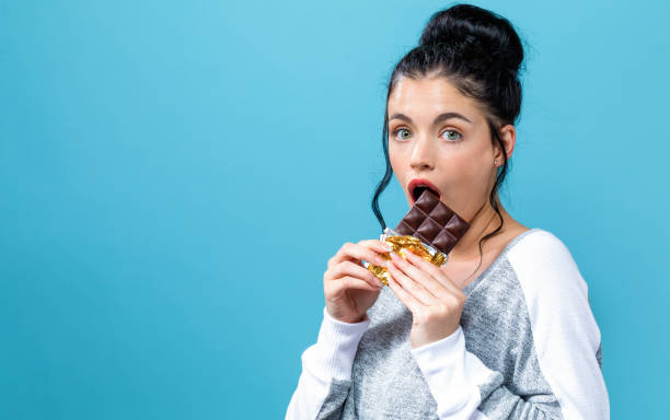 istock Young woman holding chocolate 1044939198