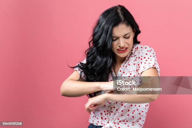 Young Woman Scratching Her Itchy Arm Stock Photo - Download Image Now - Skin, Scratching, Allergy