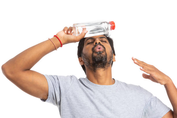 istock Male refreshing with water bottle on forehead 1044939496