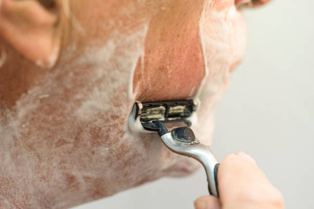 istock Senior man shaving beard in bathroom 1044939746