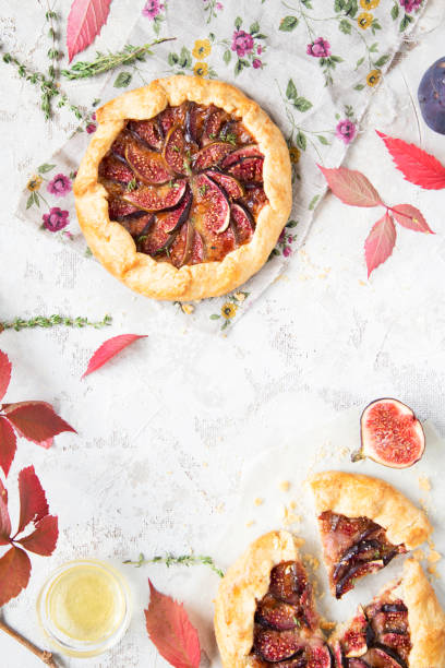 istock Crostata (pie) with cheese, figs, honey and thyme on grey background. 1044942554