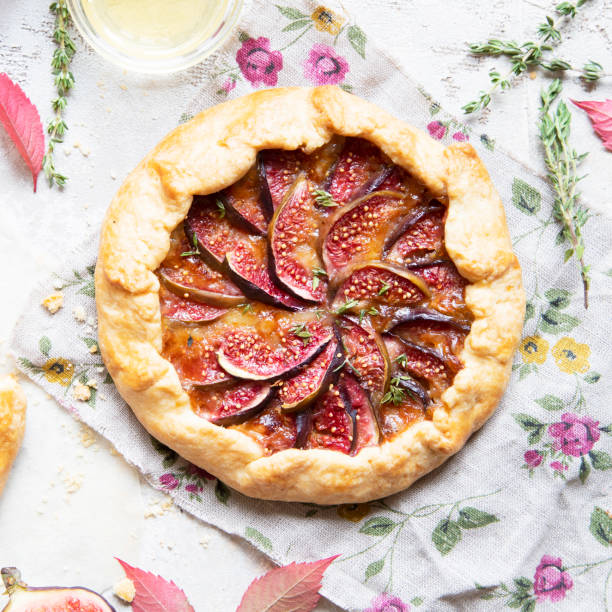 istock Crostata (pie) with cheese, figs, honey and thyme on grey background. 1044942572