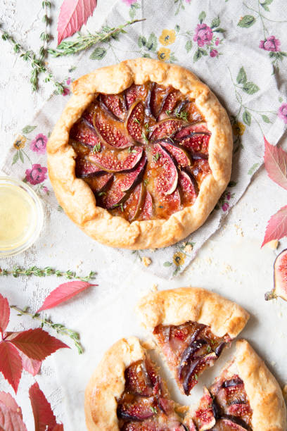 istock Crostata (pie) with cheese, figs, honey and thyme on grey background. 1044942582