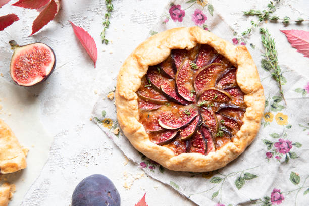 istock Crostata (pie) with cheese, figs, honey and thyme on grey background. 1044942584