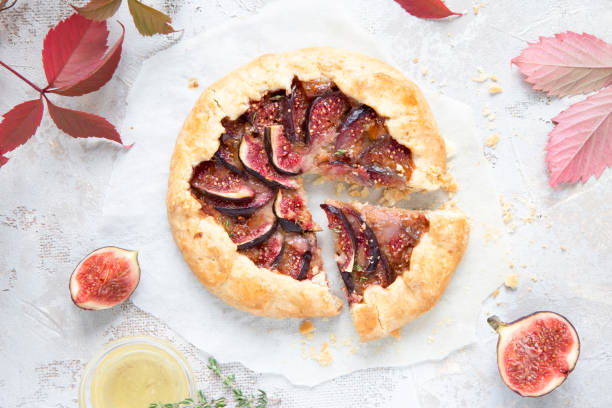 istock Crostata (pie) with cheese, figs, honey and thyme on grey background. 1044942590