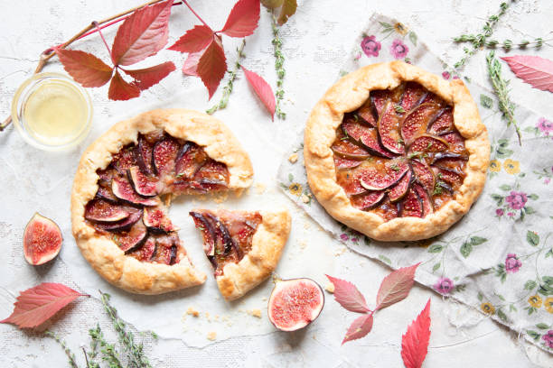 Crostata (pie) with cheese, figs, honey and thyme on grey background. Crostata (pie) with cheese, figs, honey and thyme on grey background. Flat lay. Seasonal autumn dessert. Copy space. crostata photos stock pictures, royalty-free photos & images