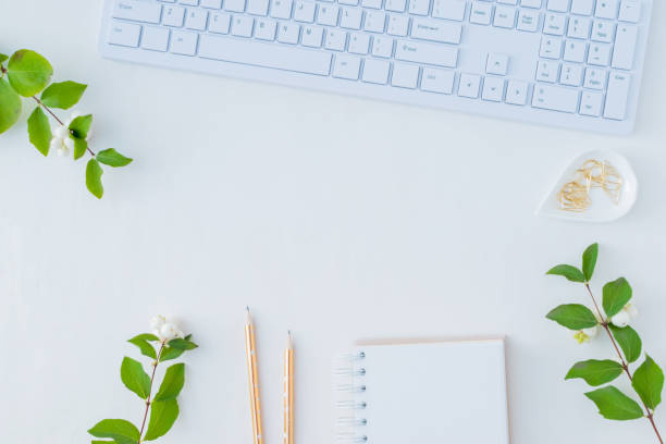 istock Flat lay desk and branch with green leaves 1044942686