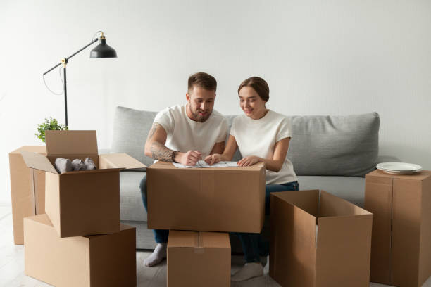 istock Excited couple looking at blueprint planning home remodeling 1044943304