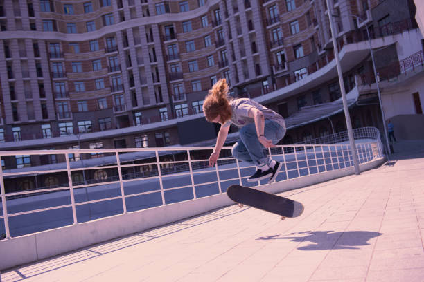 istock Concentrated longhaired male jumping with his skateboard 1044943772