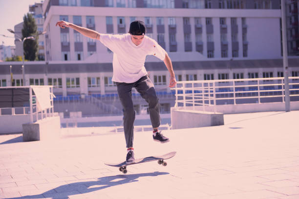 istock Concentrated brunette doing dangerous tricks on skateboard 1044943816