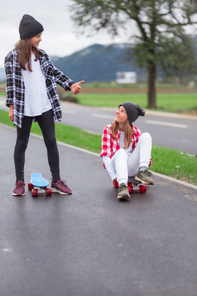 istock Two little girls with skateboards 1044946334