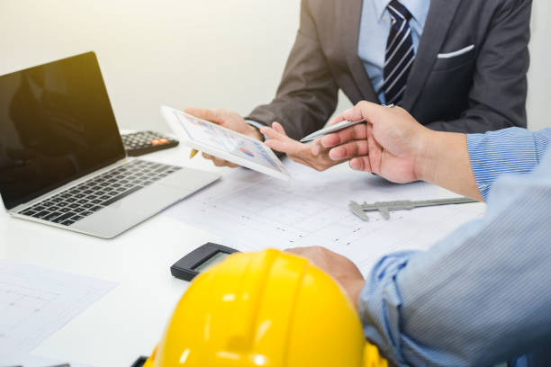 istock Businessman and engineer discuss at meeting about housing project. 1044946338