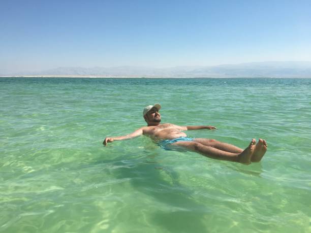 istock Man floats in the Dead Sea. 1044946514