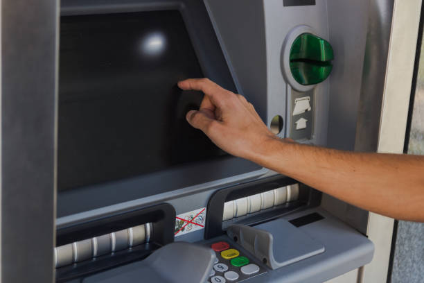 istock young man withdrawing cash from a cash machine 1044947118