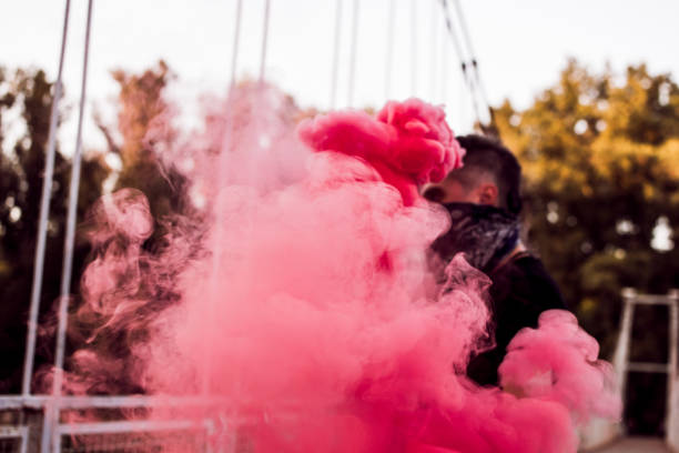 istock Young Man Rebel With Smoke Bomb In His Hand 1044950312