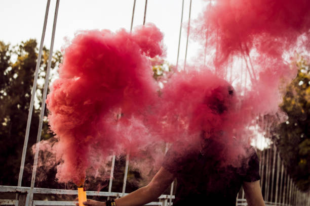 istock Young Man Holding A Smoke Bomb 1044950408