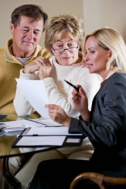 istock Senior couple talking with financial planner or consultant 104495356