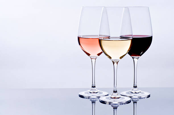 Three wine glasses filled with colorful wine Elegant crystal wine glasses filled with red, pink and white wine. wine tasting stock pictures, royalty-free photos & images