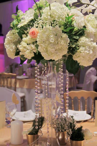 istock Wedding table flower decoration. Hydrangea, roses and orchid bouquet. Glamorous Event, celebration 1044960922