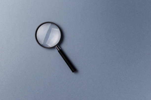istock Magnifying glass on grey background. Top view. Flat lay. Copy space. Concept 1044967782
