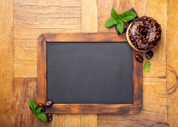istock Black chalkboard with chocolate glazed donut 1044975576