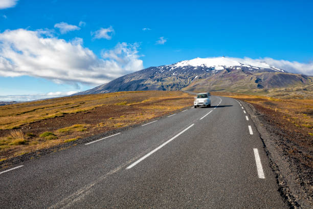 istock Car Driving Down Country Road in Iceland 1044975878