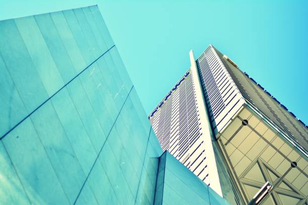 istock Modern office building on a clear sky background. Retro stylized colorful tonal filter effect 1044979928