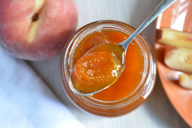 istock Peach apricot jam in a spoon top viewtop view 1044985612