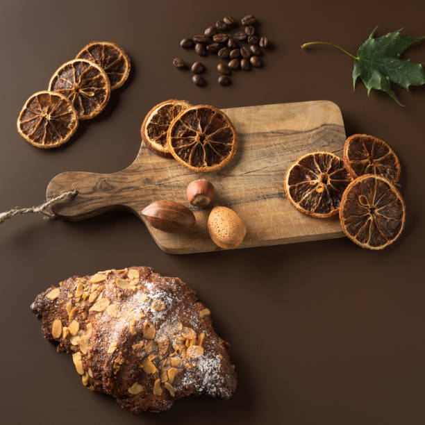 istock Croissant with nuts and powdered sugar. nuts on a wooden board. 1044985818