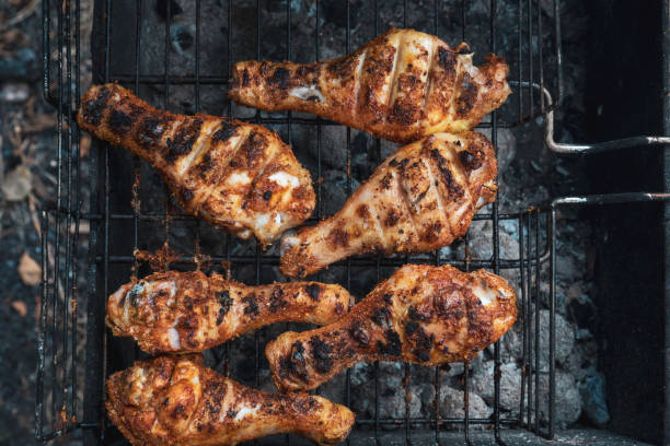 istock Grilled chicken thigh over flames on a barbecue 1044986572