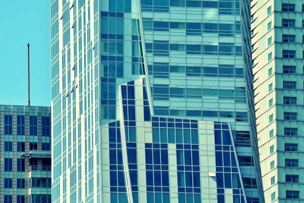 istock Modern office building on a clear sky background. Retro stylized colorful tonal filter effect 1044988824