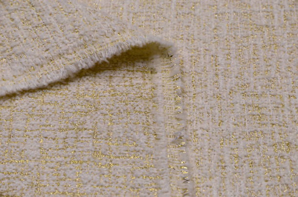 istock Woolen fabric with acrylic and lurex, ivory with gold 1044988982