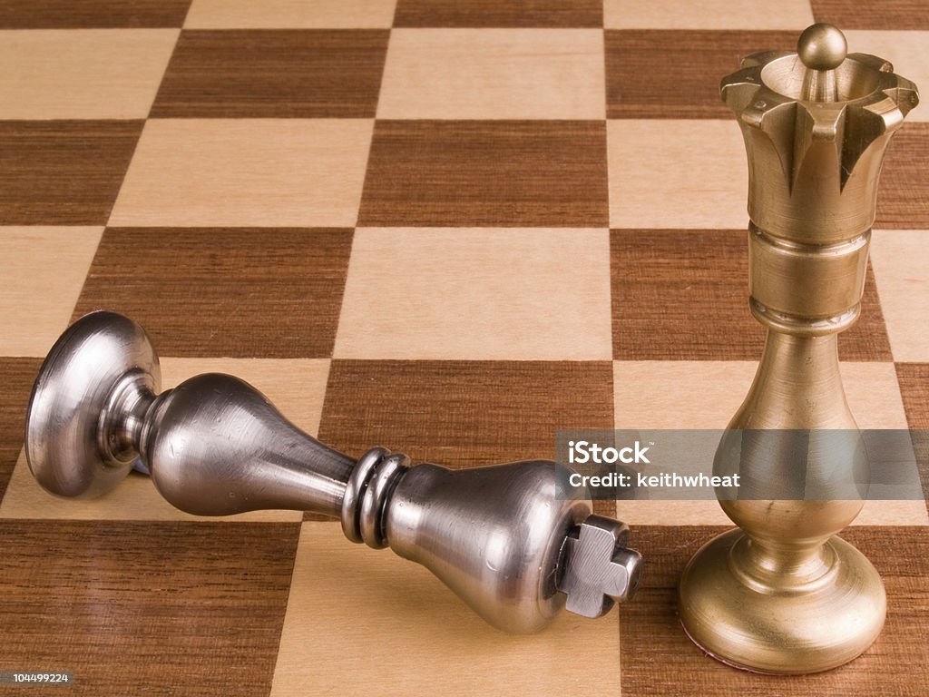 Metal chess pieces on wooden board  Adult Stock Photo