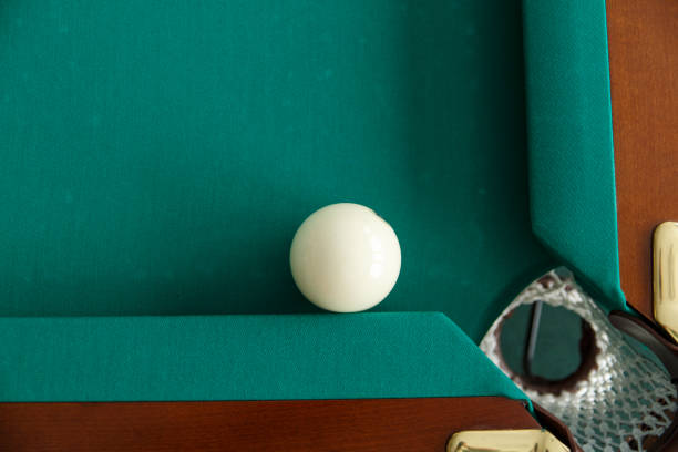 istock A pool table. Top view. The ball rolls into the pocket. 1044994354