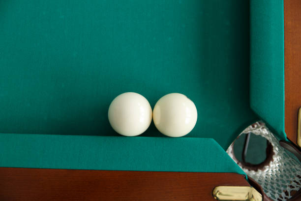 istock A pool table. Top view. The ball rolls into the pocket. 1044994362