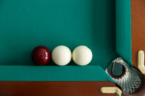 istock A pool table. Top view. The ball rolls into the pocket. 1044994384