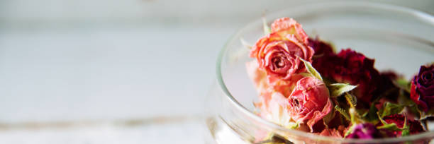 istock dried rose buds on turquoise wooden surface 1044999976