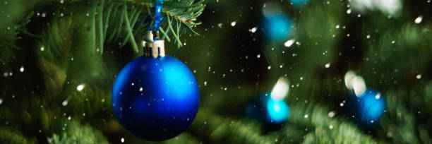 istock Forest Christmas tree branch with blue ornament. New year greeting background. Copy space. 1045003430