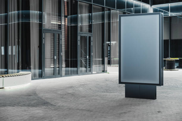 istock Blank banner stand next to facade of modern building at night, 3d rendering. 1045009342
