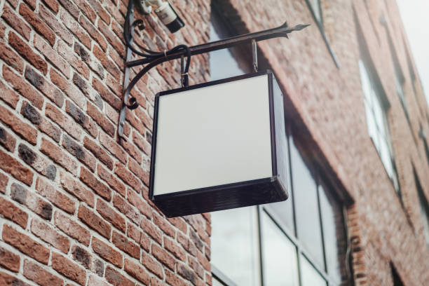 istock Blank square store signboard. Empty shop lightbox on the wall 1045011740