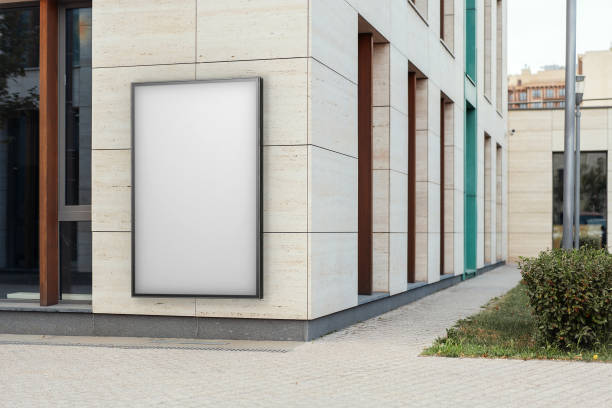 istock Blank white outdoor banner at bright modern building wall, 3d rendering. 1045012622