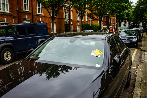 London, UK - May 12, 2018: Generic penalty charge notice (parking fine) attached to windscreen of white car parked on street in Coventry, UK