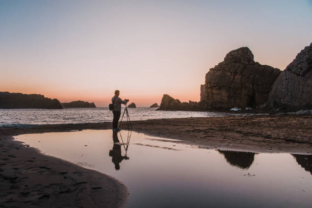 istock Photographer with tripod at sunset 1045021578