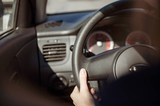 istock Hands of a female driver on steering wheel 1045026280