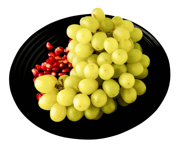 istock grapes and pomegranate isolated on white background. grapes and pomegranate on a plate . 1045029398