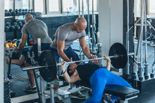istock Man training a girl in gym 1045033552