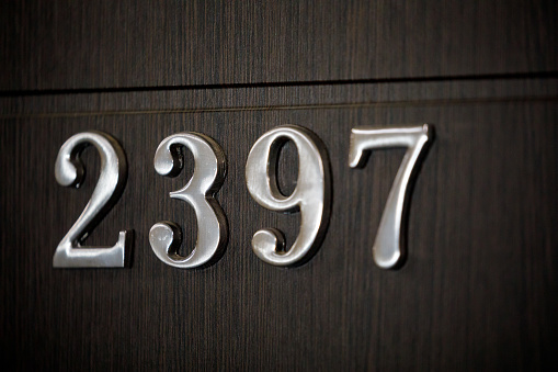 House number text 2397 two sign on wooden door