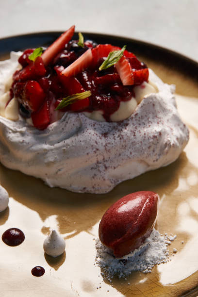 istock Meringue, Pavlova cake with berries and ice cream 1045048602