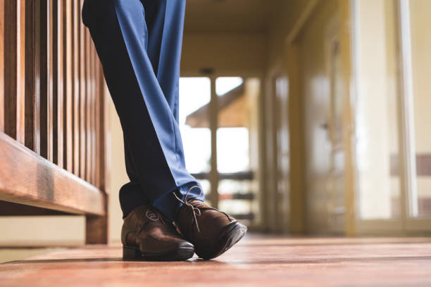Selfie of woman's legs in sneakers on a walkway.