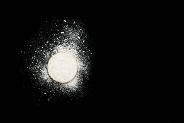 istock Gold coin sprinkled with cocaine on a black table 1045053892